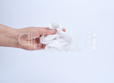 female hand holding a clean white paper napkin for face and body