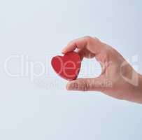 red heart in a human hand on a white background