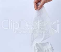 female hand holding a clean white paper napkin for face and body