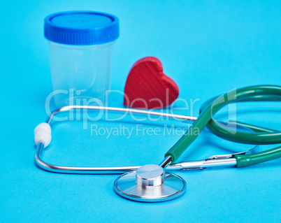 green medical stethoscope and  red decorative heart