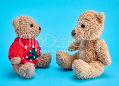 two teddy bears are sitting
