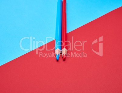 two wooden pencils on an abstract colored background