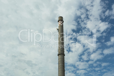 Old factory chimney on blue sky