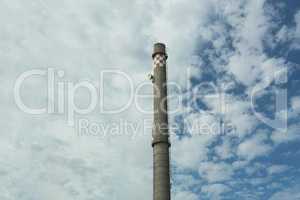 Old factory chimney on blue sky