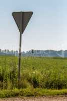 Road sign next to the rural road.