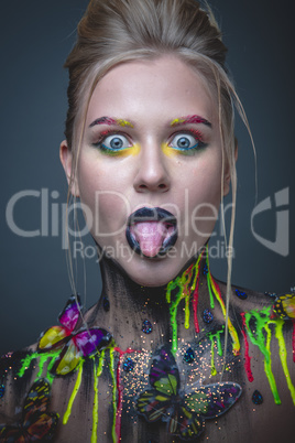 Young girl with creative makeup with butterflies