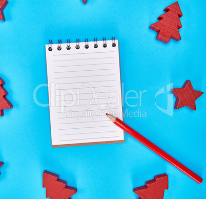 notebook with empty white sheets in line and red wooden pencil