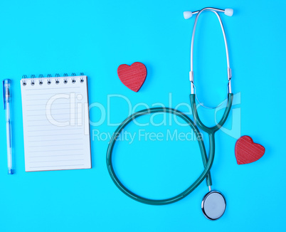 f paper in a line and a medical stethoscope