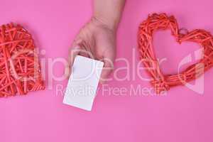 empty white rectangular business card in a female hand