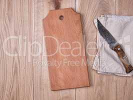 wooden kitchen cutting board and a gray towel