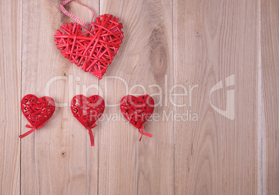 red hearts on a wooden background of oak boards