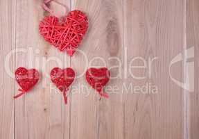 red hearts on a wooden background of oak boards