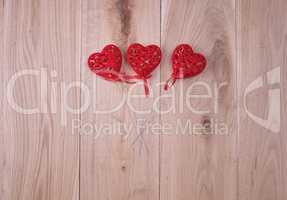 red hearts on a wooden background of oak boards