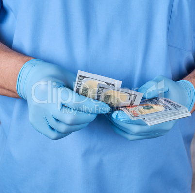 doctor in blue uniform and gloves recounts money