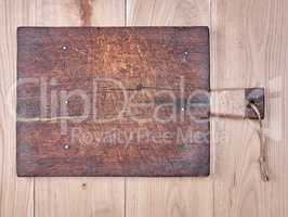 very old brown square cutting board with a handle