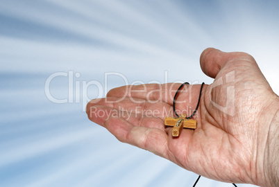 Hand with a wooden cross