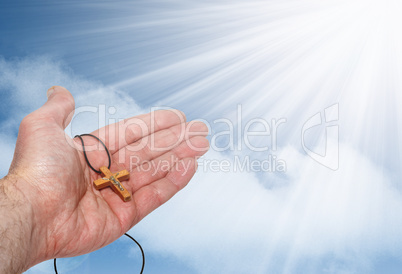 Hand with a wooden cross