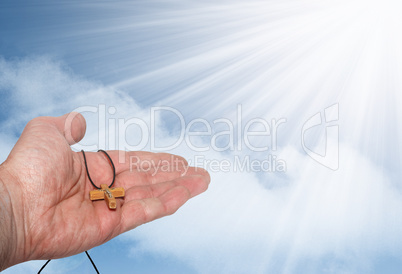 Hand with a wooden cross