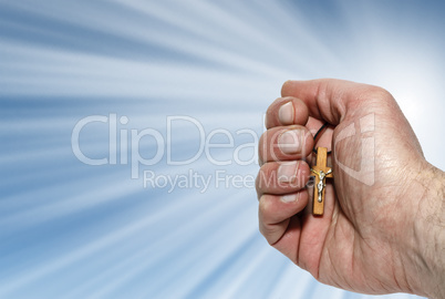 Hand with a wooden cross