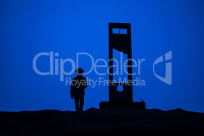 Horror view of Guillotine. Close-up of a guillotine on a dark foggy background.