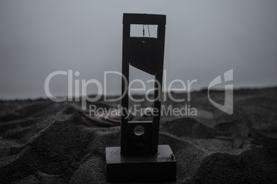 Horror view of Guillotine. Close-up of a guillotine on a dark foggy background.