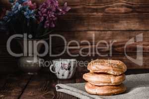 Eclairs stack on table with cup of coffee