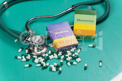 Health care medical and sickness concept. Pills and medical equipment background with a drug box fake write "Medicine".