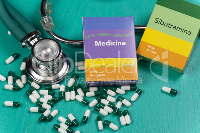 Health care medical and sickness concept. Pills and medical equipment background with a drug box fake write "Medicine".