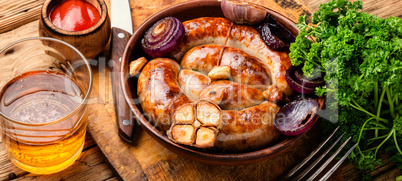 Grilled sausages on wooden table