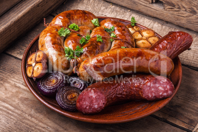 Grilled sausages on wooden table
