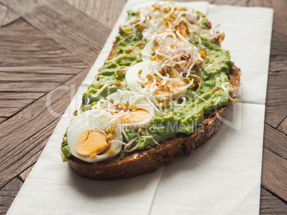 Organic bread with avocado cream and eggs