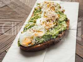 Organic bread with avocado cream and eggs