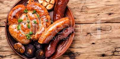 Grilled sausages on wooden board