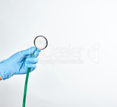 blue sterile gloved hand holding a green medical stethoscope