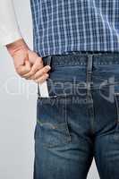 man puts an empty white paper business card in his back jeans po