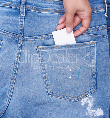 hand sticks an empty paper business card into the back pocket