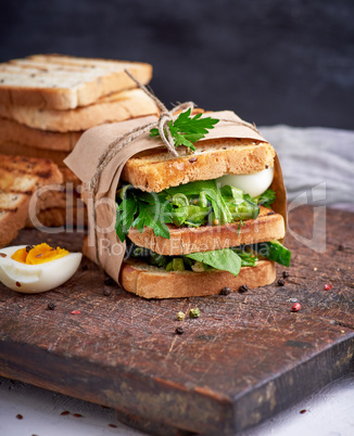 sandwich of French toast and lettuce leaves and boiled egg