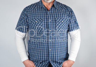 torso of a man in a blue checked shirt