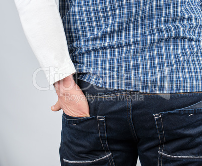 male hand shoved into the back jeans pocket