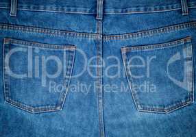 fragment of blue jeans with back pockets