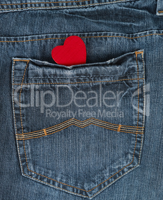 small red heart in the back pocket of blue jeans