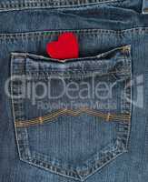 small red heart in the back pocket of blue jeans