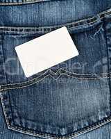 empty paper card lies on blue jeans