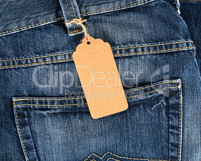 tied brown blank tag on blue jeans