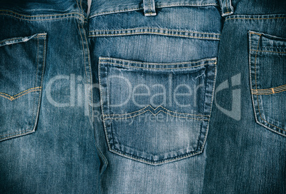several blue classic jeans folded in a row