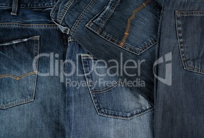 Lots of blue classic jeans stacked chaotically