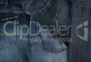 Lots of blue classic jeans stacked chaotically