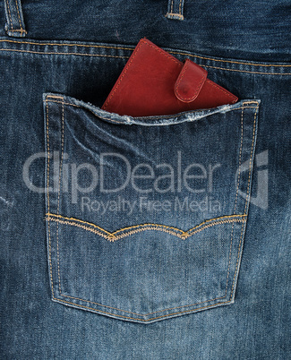 Brown leather wallet in the back pocket of blue jeans