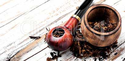 Smoking pipe on a wooden table