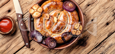 Grilled sausages on wooden board